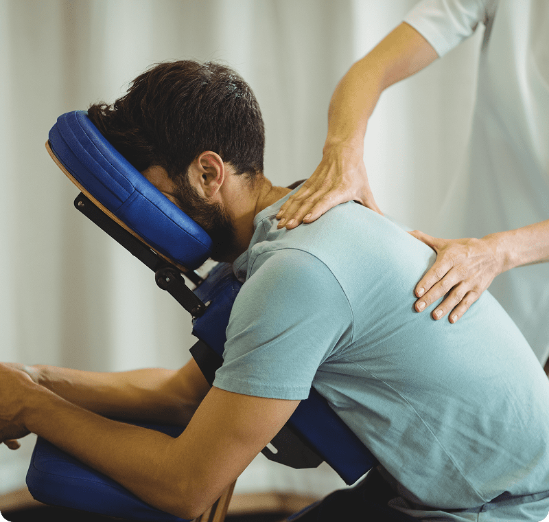 Man receiving massage in a massage chair.