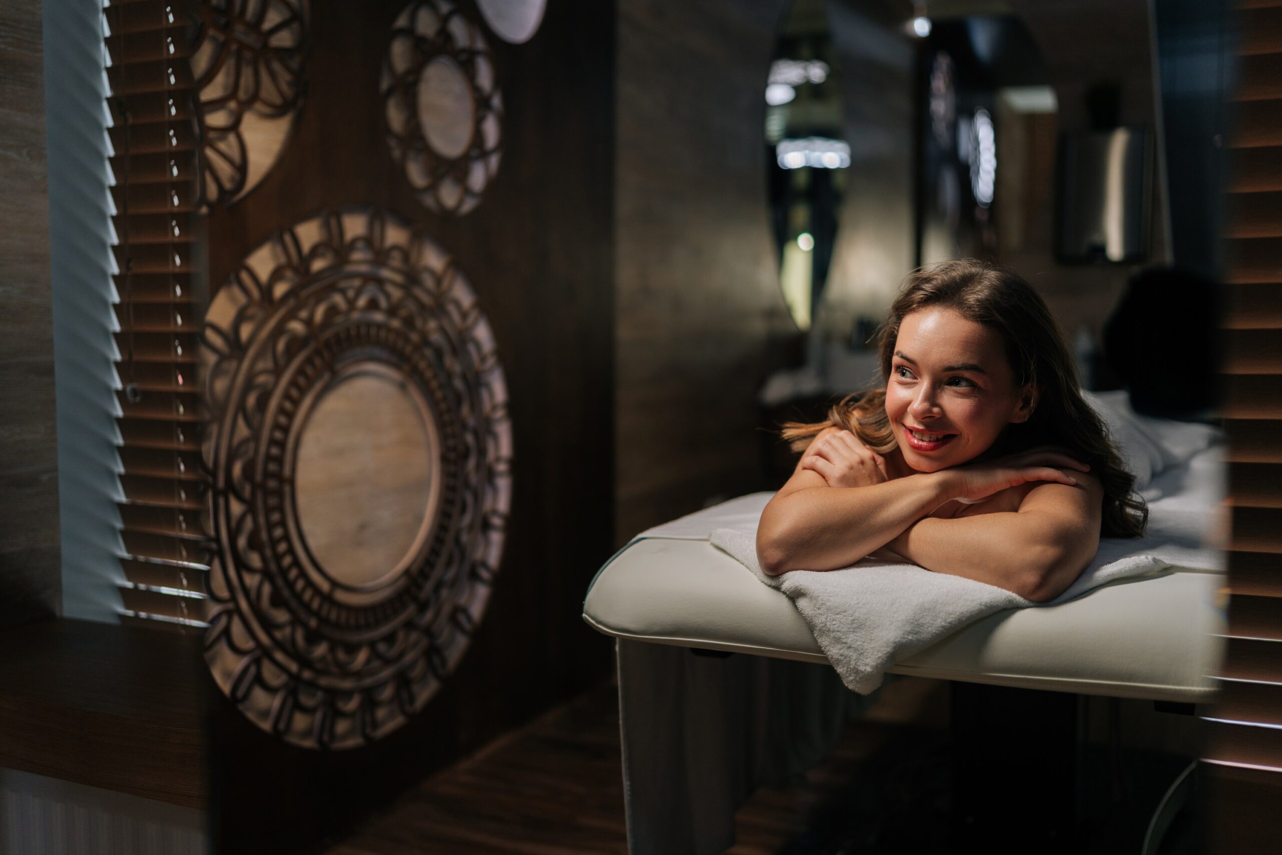 Woman relaxing on spa massage table.