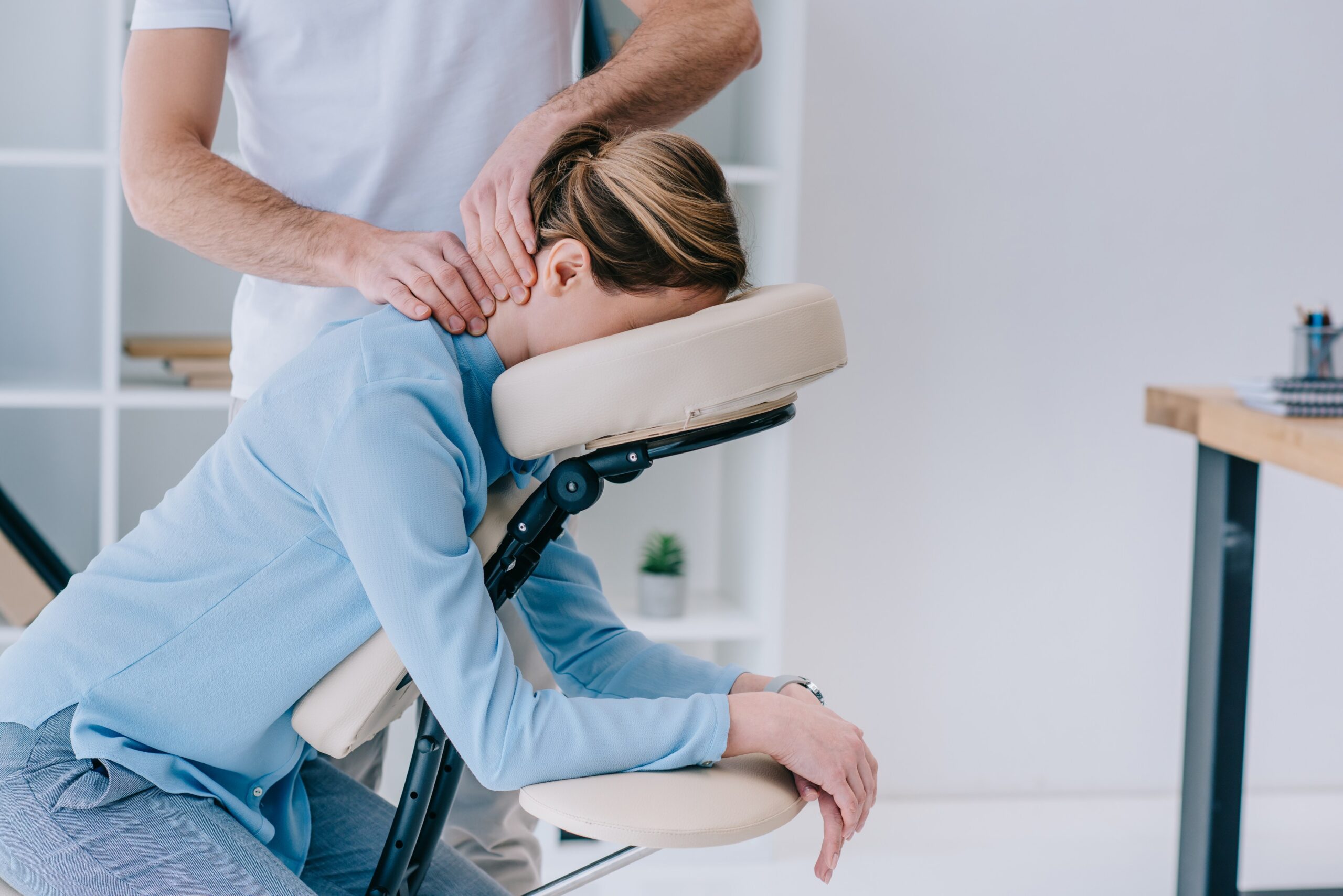 Person receiving a seated neck massage.